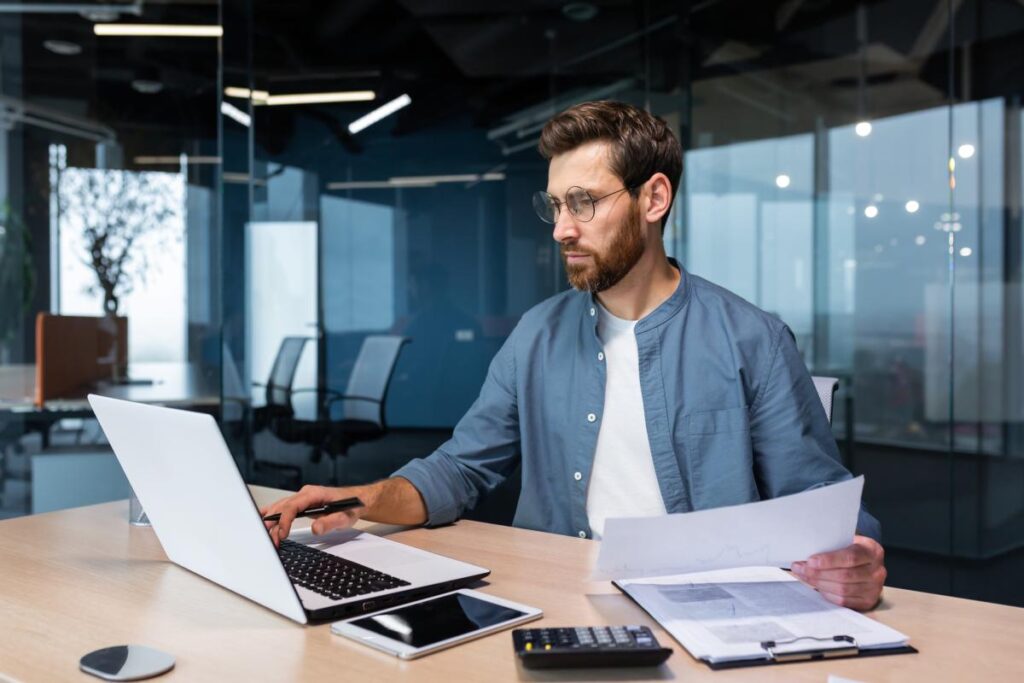 Focused financier accountant on paper work inside office