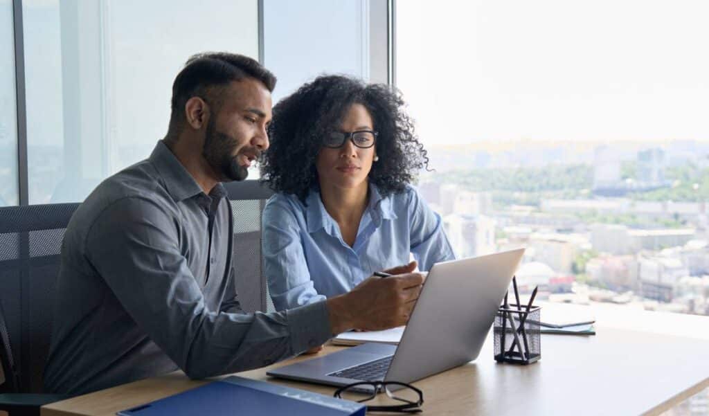 An insurance team accesses mission-critical software on a laptop