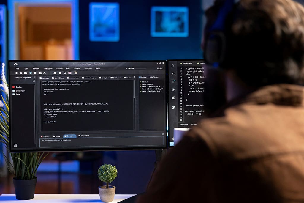 A programmer reviews his source code for issues before deployment.