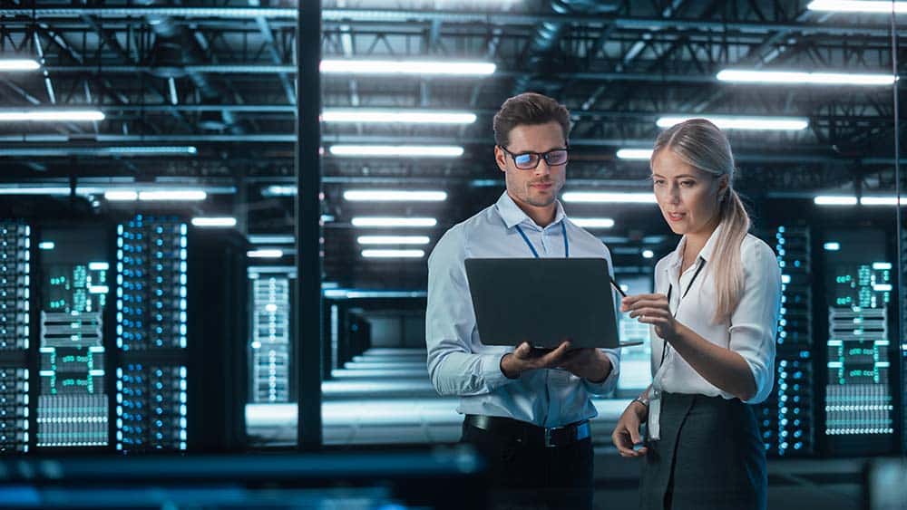 Two programmers at work at a data storage facility.
